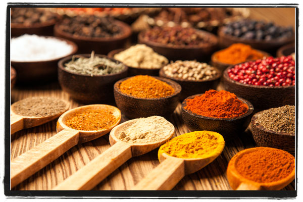 Wooden spoons showing a variety of spices