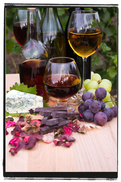 Wine glasses, fruit, chocolate, and vegan cheese display