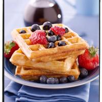 Waffles with berries and maple syrup